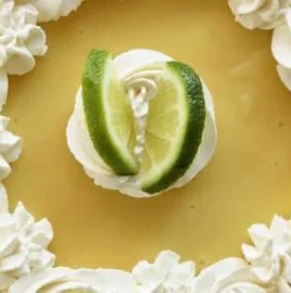 Slice of Easy Key Lime Pie with whipped cream and lime garnish