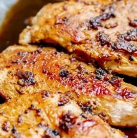 Plate of easy spicy honey chicken garnished with green onions