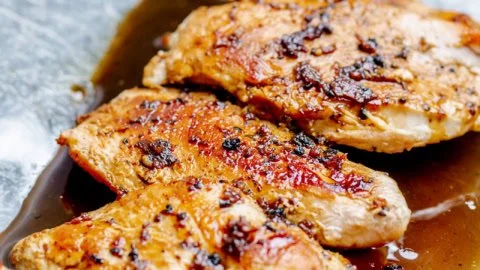 Plate of easy spicy honey chicken garnished with green onions
