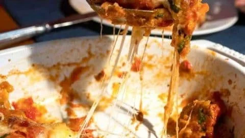 Delicious slice of homemade Eggplant Parmesan topped with melted cheese and herbs