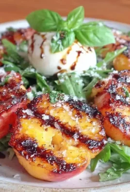 Fresh Grilled Peach and Burrata Salad with greens and vinaigrette