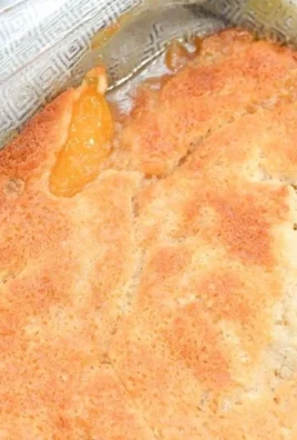 Delicious Georgia Peach Cobbler topped with golden crust and fresh peaches