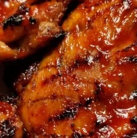 Grilled Spicy BBQ Chicken Thighs with smoky seasoning on the grill