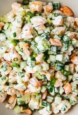 Healthy cucumber shrimp salad served in a bowl with fresh herbs and dressing.