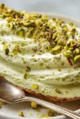 A bowl of homemade Italian-style pistachio cream with a spreader.