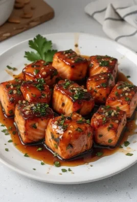 Honey butter garlic glazed salmon bites served on a plate.