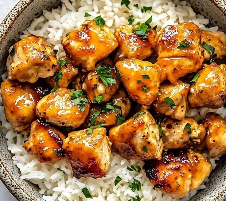 Delicious Hot Honey Chicken Bowls topped with spicy honey sauce and fresh garnishes