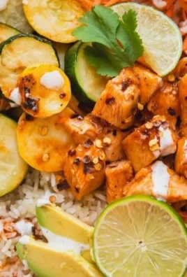 Delicious hot honey chicken bowl garnished with fresh herbs
