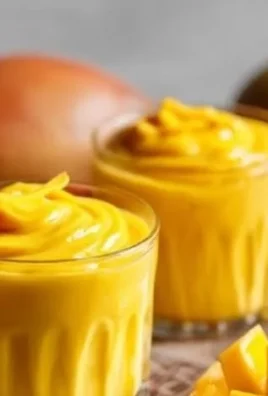 A plate of Mango Sticky Rice topped with fresh mango slices and coconut sauce
