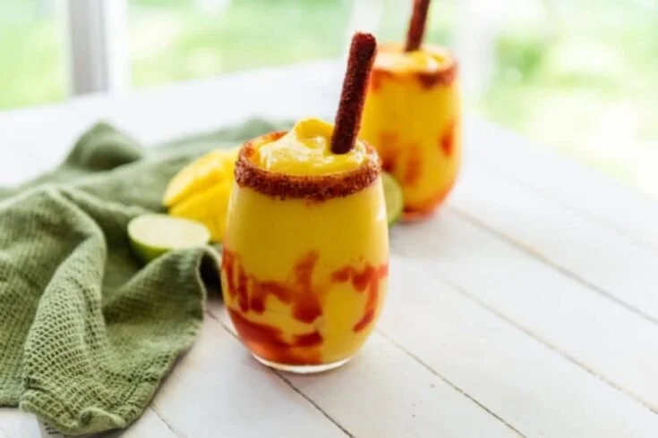 Delicious Mexican Mangonada topped with chamoy and Tajín seasoning