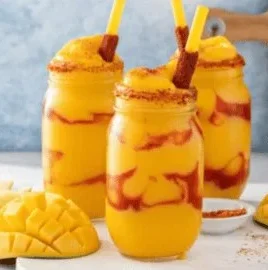 Delicious homemade Mexican Mangonada in a colorful cup with fresh fruit