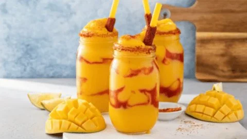 Delicious homemade Mexican Mangonada in a colorful cup with fresh fruit