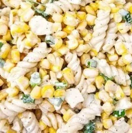 Bowl of Mexican street corn pasta salad topped with fresh cilantro and lime