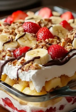 No-Bake Banana Split Cake topped with fruit and whipped cream