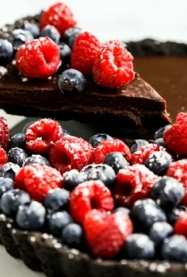 Delicious no bake dark chocolate tart garnished with berries