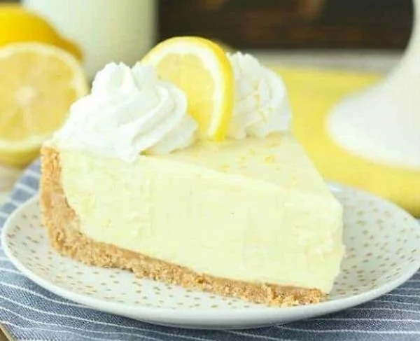 No-bake lemon cream pie topped with fresh whipped cream and lemon zest