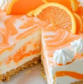 No-bake orange creamsicle cheesecake topped with orange slices and whipped cream