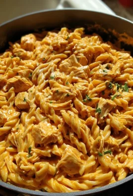 Delicious one-pot creamy honey BBQ chicken pasta in a white bowl.