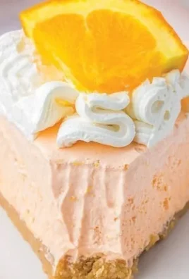 Slice of Orange Jello Creamsicle Pie on a plate
