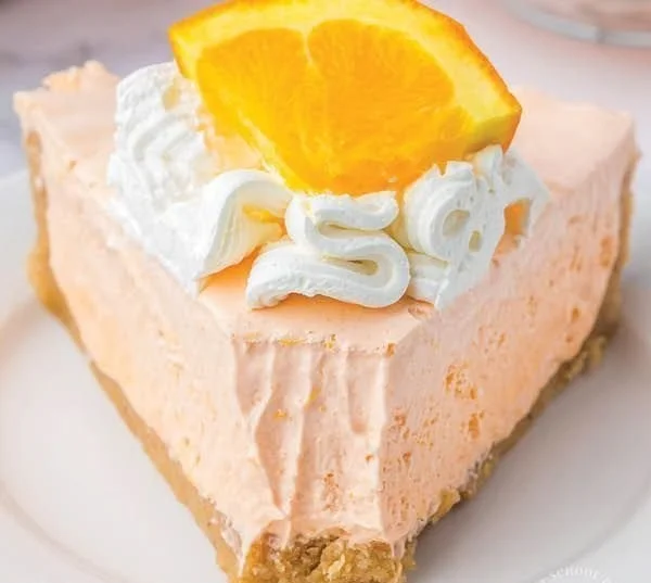 Slice of Orange Jello Creamsicle Pie on a plate