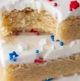Patriotic sugar cookie bars topped with red, white, and blue sprinkles.