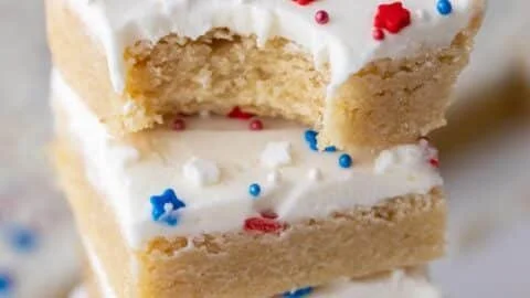 Patriotic sugar cookie bars topped with red, white, and blue sprinkles.