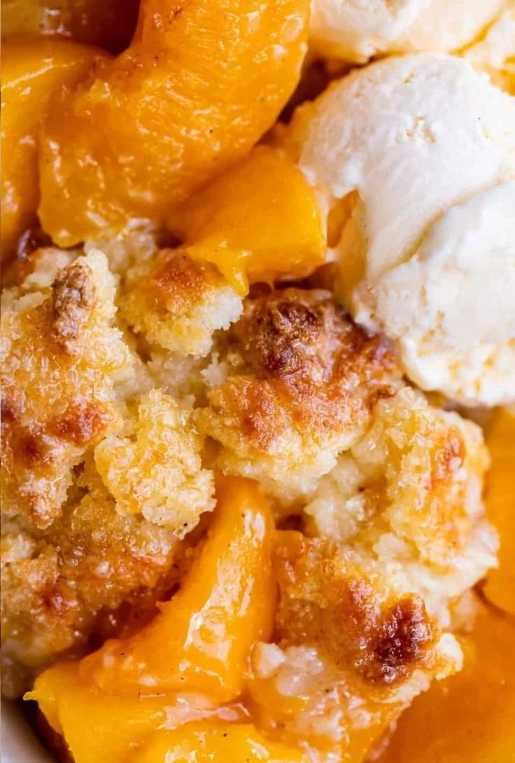 Delicious homemade peach cobbler with golden crust and fresh peaches