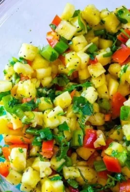 Fresh pineapple salsa served in a bowl with cilantro and lime