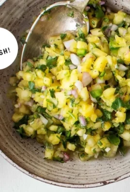 Delicious pineapple salsa served in a bowl with fresh ingredients.