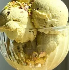 Bowl of pistachio cottage cheese ice cream sprinkled with chopped nuts