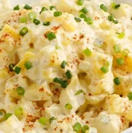 Delicious homemade potato salad with fresh herbs and vegetables