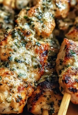 Savory Garlic Parmesan Chicken Skewers served on a grill.