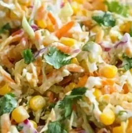 Bowl of vibrant spicy corn slaw with fresh vegetables and spices