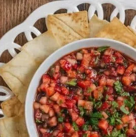 Fresh strawberry salsa with balsamic glaze and herbs in a bowl
