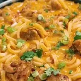 Delicious Thai-inspired coconut red curry chicken udon bowl with vibrant colors and spices.