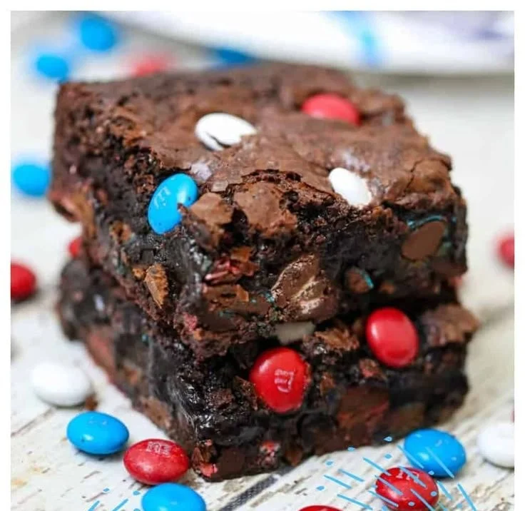Delicious homemade brownies on a cooling rack, showcasing a rich chocolate texture.