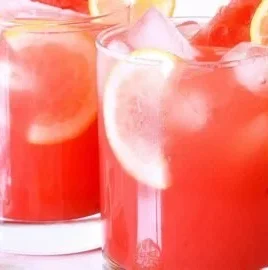 Refreshing watermelon lemonade served in a glass with a slice of watermelon