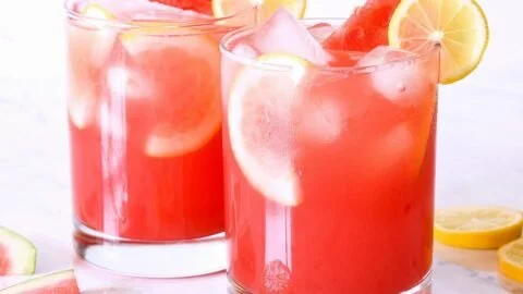 Refreshing watermelon lemonade served in a glass with a slice of watermelon