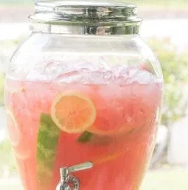 Refreshing watermelon lemonade in a glass with mint garnish.