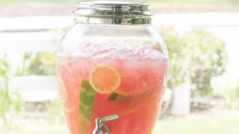 Refreshing watermelon lemonade in a glass with mint garnish.