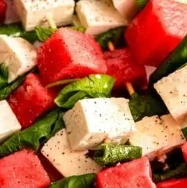 Delicious watermelon skewers topped with feta cheese, mint, and basil.