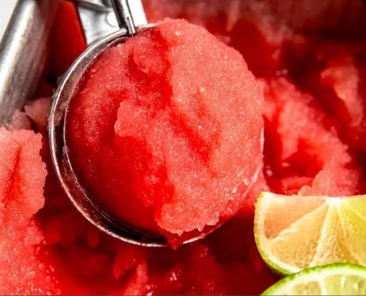 Bowl of refreshing watermelon sorbet garnished with mint leaves