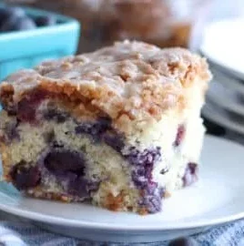 Delicious homemade blueberry coffee cake on a wooden table