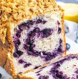 Loaf of freshly baked bread machine blueberry bread with blueberries on top