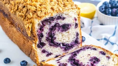 Loaf of freshly baked bread machine blueberry bread with blueberries on top