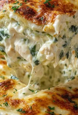 Delicious Chicken Alfredo Lasagna layered with creamy sauce and chicken.