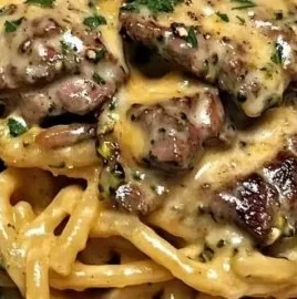 Delicious Cowboy Butter Steak served with broccoli linguine.