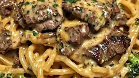 Delicious Cowboy Butter Steak served with broccoli linguine.