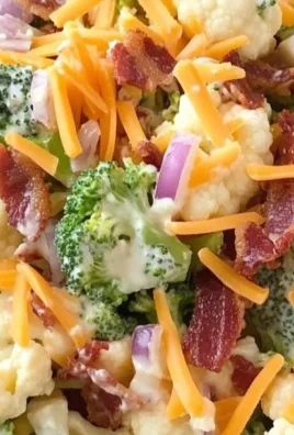 Delicious creamy broccoli cauliflower salad in a serving bowl.