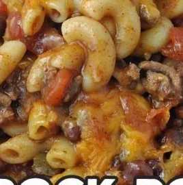 Crock Pot Cheddar Chili Mac with melted cheese and chili peppers in a bowl